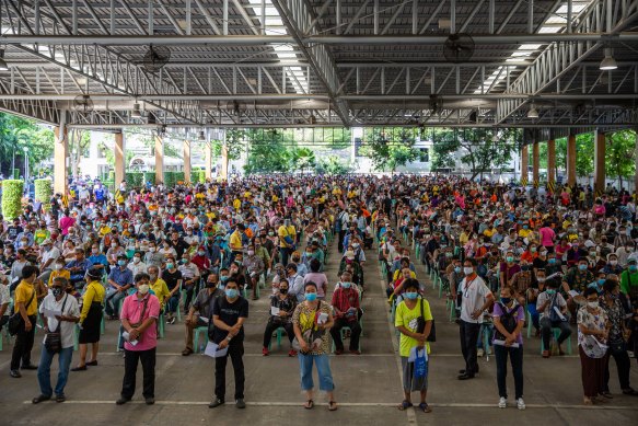 Hundreds of unemployed people wait to apply for government financial aid in Bangkok, Thailand.