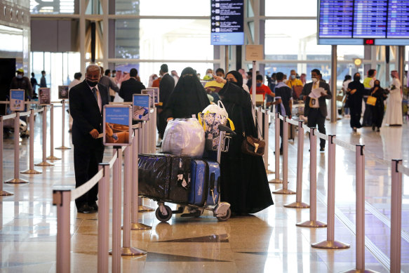 Saudi passengers enter King Abdulaziz International Airport in Jiddah, Saudi Arabia, where vaccinated citizens are allowed to leave the kingdom for the first time in more than a year.