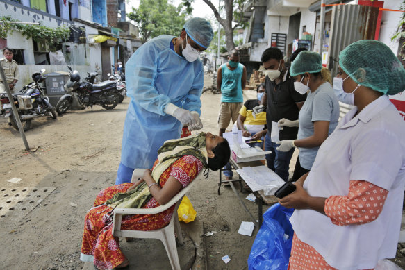 A health worker takes a nasal swab sample to test for COVID-19 in Ahmedabad, India, on September 6.