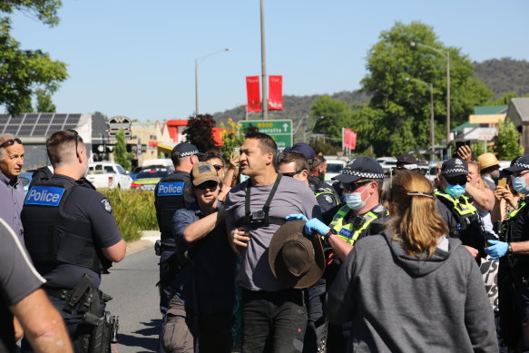 A man is arrested at the rally.