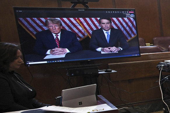 Donald Trump and his lawyer Todd Blanche (right) appear by video before a hearing began in Manhattan criminal court on Tuesday.