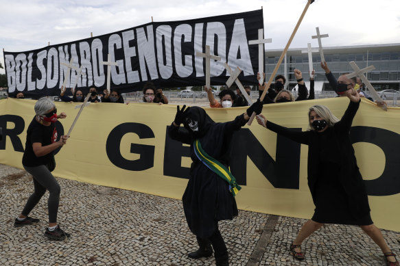A protest against Jair Bolsonaro’s handling of the COVID-19 pandemic outside Planalto presidential palace in Brasilia, Brazil, Friday, March 19, 2021.