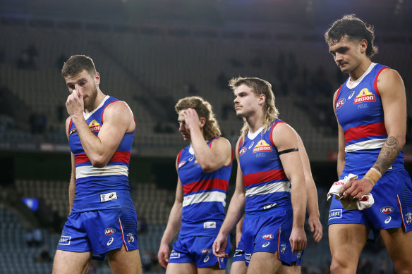 Western Bulldogs players leave the field after the loss to West Coast. 