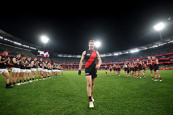 Zach Merrett of the Bombers walks off the ground following his 250th game.