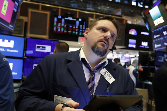 Trader Michael Milano works on the floor of the New York Stock Exchange, where stocks opened sharply lower on Thursday.