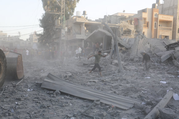 Palestinians look for survivors after an Israeli strike on the Gaza Strip in Rafah on Monday.