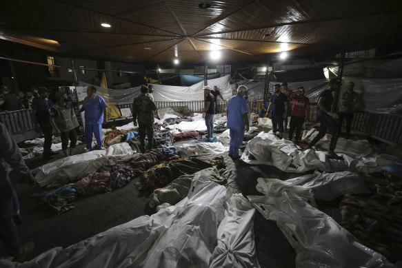 Bodies of Palestinians killed by an explosion at the Al Ahli Arab Hospital are gathered in Gaza City.