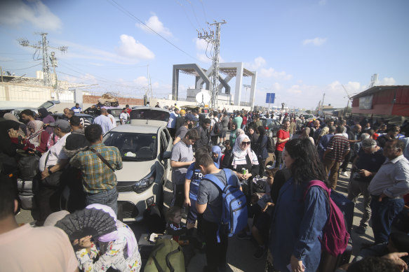 Palestinians in Gaza wait to cross to the Egyptian side at the Rafah border on Monday.