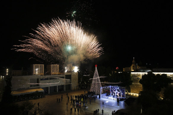 Palestinian Christians attend the lighting of a Christmas tree outside the Church of the Nativity, traditionally believed by Christians to be the birthplace of Jesus Christ in the West Bank city of Bethlehem.