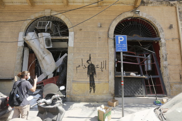 Graffiti reading 'The Hanging' is seen on a damaged building in downtown Beirut.