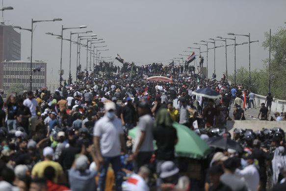 Protesters gather on a bridge leading to the Green Zone area in Baghdad, Iraq, on Saturday.