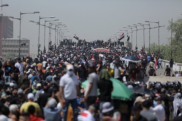 Protesters gather on a bridge leading to the Green Zone area in Baghdad, Iraq, on Saturday.