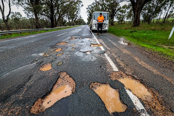 Tow truck driver Chris Welsh near the potholes on the A300 between Benalla and Mansfield.