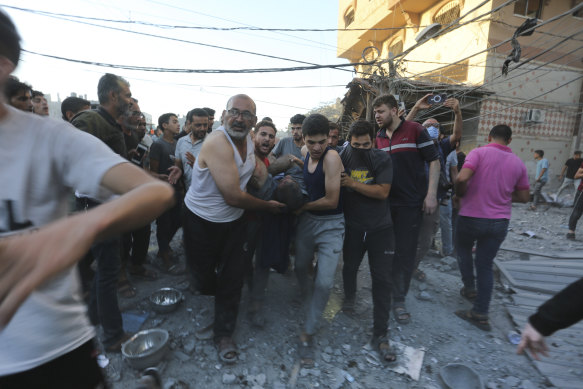 Palestinians evacuate survivors after an Israeli strike on the Gaza Strip this week.