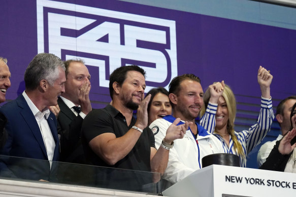 Actor Mark Wahlberg, second left, brand ambassador for fitness chain F45, applauds as F45 listed in 2021 with Greg Norman among those in attendance.  