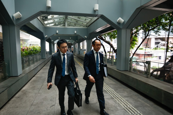 Lawyer Gary Leung (right), representing Tina Zou, leaves the High Court in Hong Kong in July.