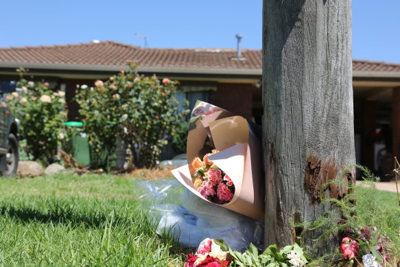 Flowers outside the home where a baby’s body was found in a freezer.