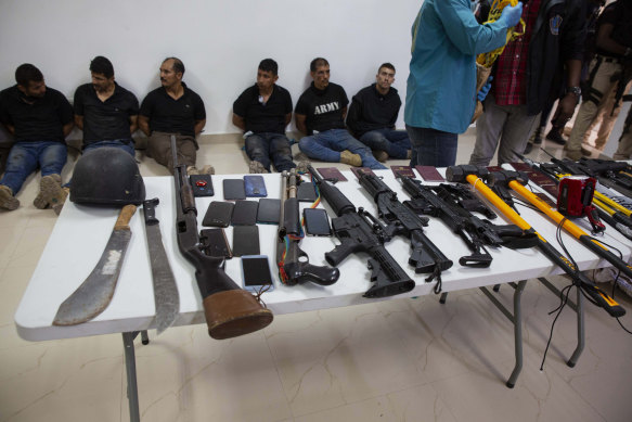 Suspects in the assassination of Haiti’s President Jovenel Moise are shown to the media, along with the weapons and equipment they allegedly used in the attack.