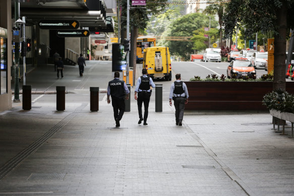 Police patrol empty streets during Brisbane’s lockdown, the strictest of the pandemic so far.