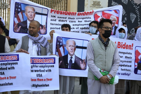 Former Afghan interpreters hold placards during a demonstrations against the US government, in front of the US Embassy in Kabul, Afghanistan, Friday, June 25, 2021. 