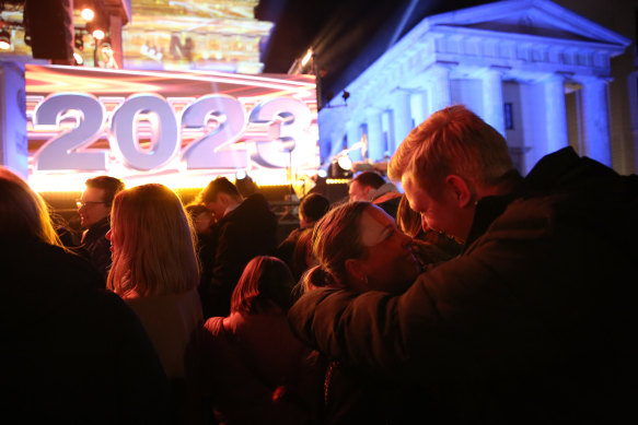 Visitors attend New Year’s celebrations at the Brandenburg Gate on December 31, 2023 in Berlin, Germany. 