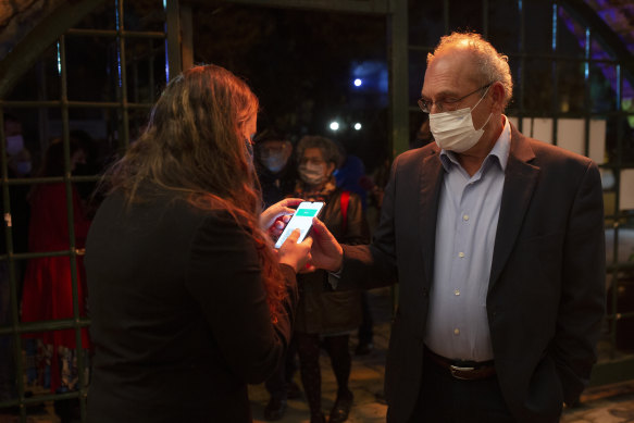 A man presents his Green Pass as  proof of coronavirus vaccination,  at the Khan Theatre in Jerusalem.