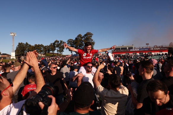 Andrea Agamemnonos  celebrates victory with of Sydney United 58 fans.
