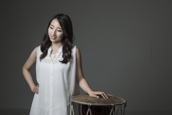 Woo Minyoung with her changgo, a traditional Korean drum.