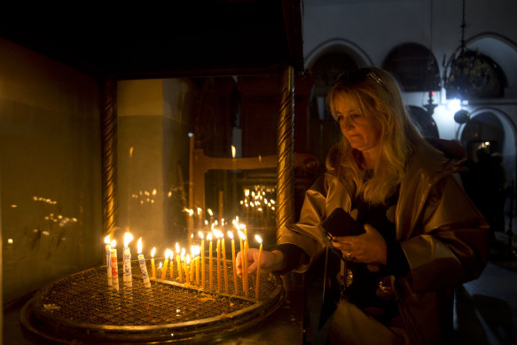 A visitor places candles at the Church of the Nativity in Bethlehem, built at the site where many Christians believe Jesus was born.
