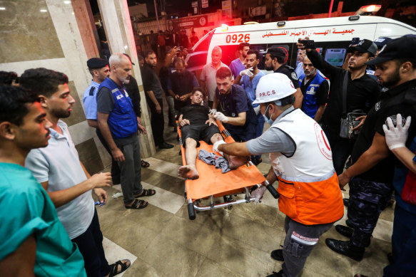 Palestinians injured in Israeli air raids arrive at Nasser Medical Hospital in Khan Yunis, in the southern Gaza Strip.