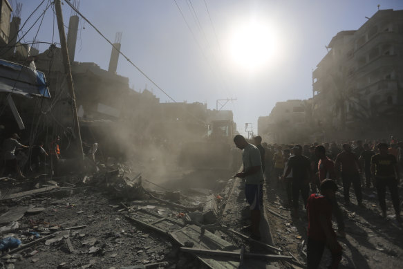 Palestinians look for survivors after an Israeli airstrike in Rafah, Gaza on Thursday.
