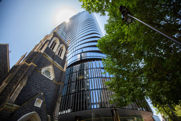 Wesley Place towers loom over a historic church on Lonsdale Street.
