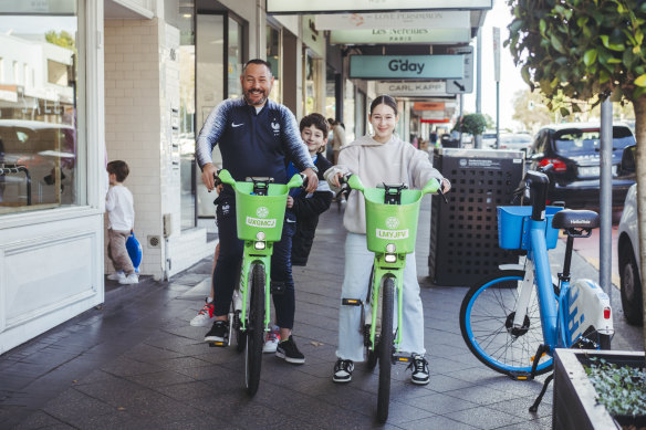 Elia Eliopoulou, with kids Jack, 10, and Sophie, 12, using Lime bikes to explore Sydney on Wednesday.
