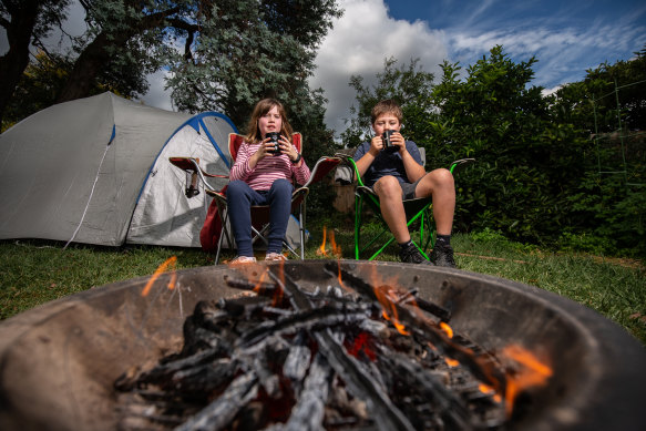 Archie Smith, 11, and his sister Dana, 8, have been whittling and drinking tea in their backyard.