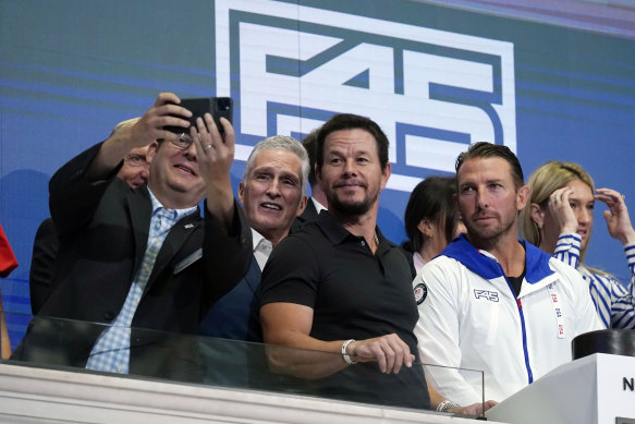 Mark Wahlberg and F45 co-founder Adam Gilchrist have been targeted by a shareholder class action while Greg Norman (in the background) is also suing the company.