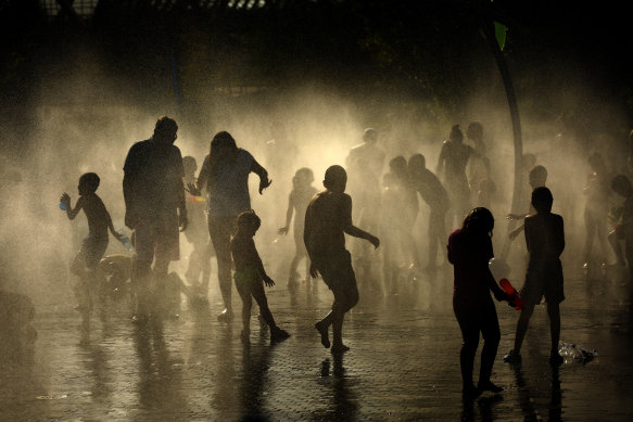 People cooling off at an urban beach in Madrid during a heatwave in June 2019 as hot air rolled in from north Africa.
