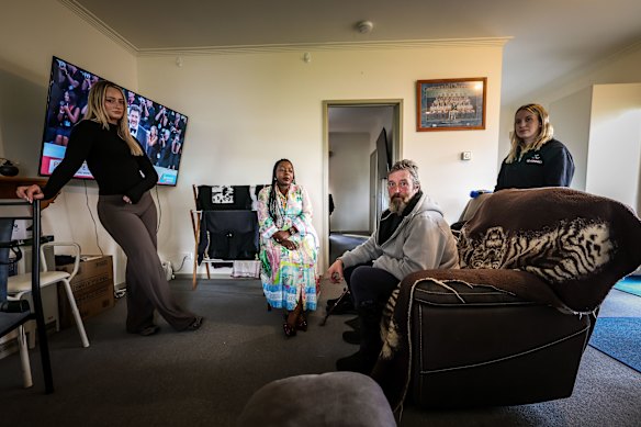 Barry at home with (from left) support worker Ella Williams and support co-ordinators Prue Muvengi and Ellie McInnes.