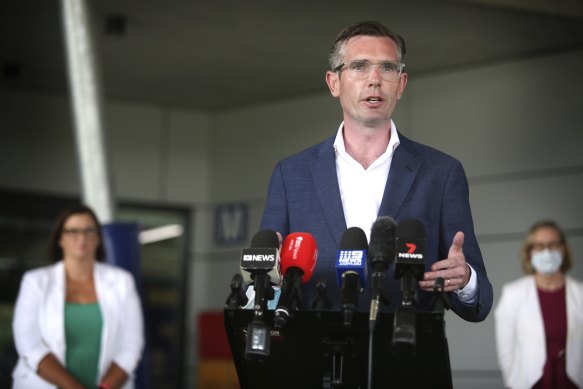 NSW Premier Dominic Perrottet outlines  the government’s return to school strategy with Education Minister Sarah Mitchell (left) on Sunday.