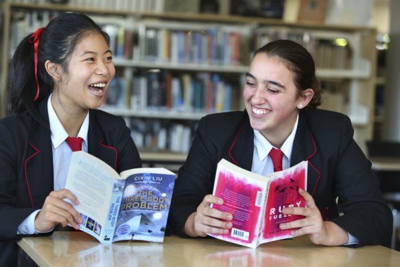 Year 10 Queenwood students Penny Jin and Lucy Colquhoun-Thomson with their books at the school’s library.