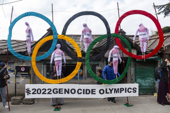 Exile Tibetans use the Olympic Rings as a prop as they hold a street protest against the holding of 2022 Winter Olympics in Beijing