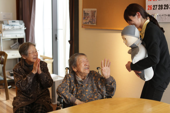 Residents of an aged-care facility meet a remote-controlled “humanoid” robot in Natori, Japan.