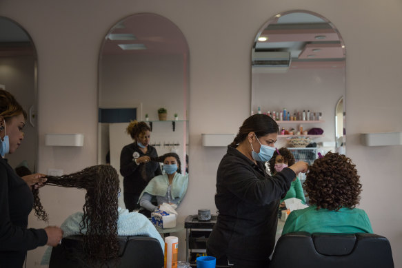 Women receive hair treatments at a salon in Cairo.