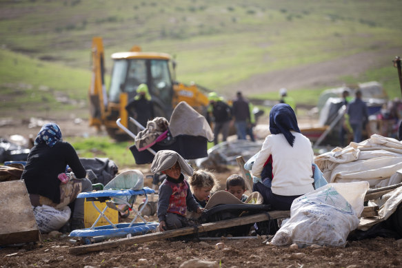 Residents of Khirbet Humsu watch Israeli troops demolish the village.