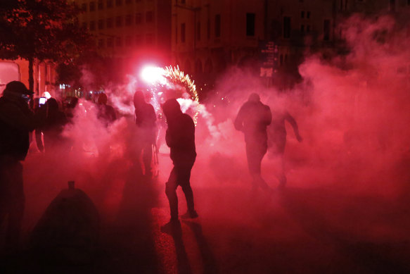 Riot police tear gas and and protesters' fireworks combine to add colour to the chaos.