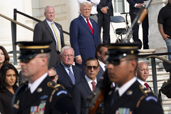 Trump and others watch the changing of the guard at the Tomb of the Unknown Solider on Monday.