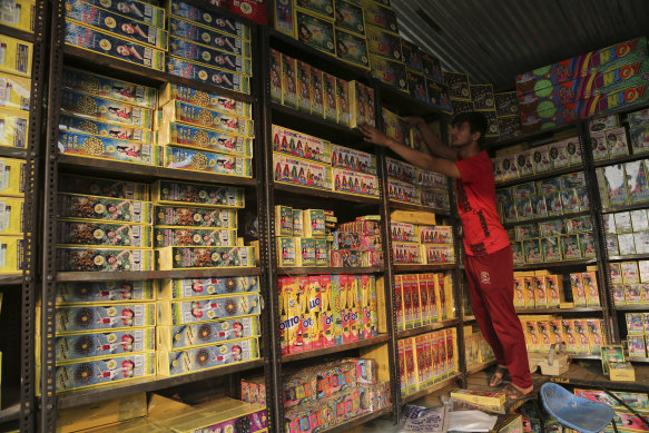 A man arranges packets of firecrackers for sale, on Wednesday the eve of Diwali, the Hindu festival of lights, in Jammu, India.