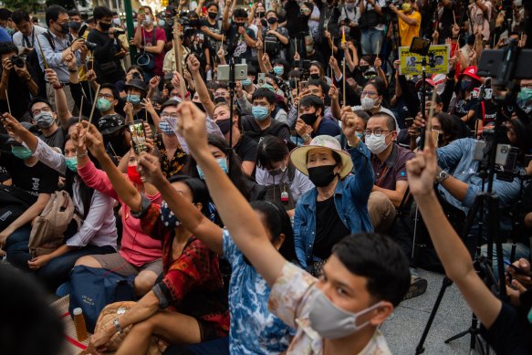 Anti-government protesters wave chopsticks as makeshift wands while they take part in a Harry Potter themed rally in Bangkok on Monday.