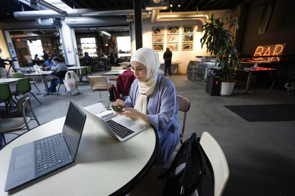 Mona Marwari, of Dearborn, calls a voter for the Listen to Michigan uncommitted vote campaign in Detroit on Tuesday.