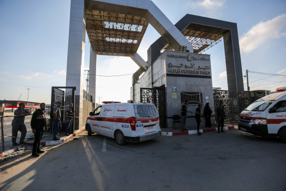 Wounded Palestinians enter the Rafah crossing yesterday to receive medical care for the first time since the war began.