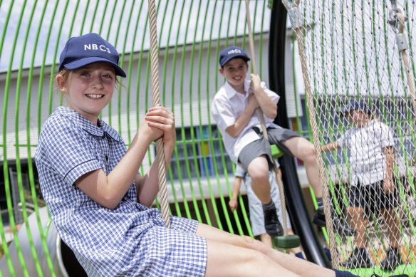 Students at Northern Beaches Christian School hanging around on new playground equipment.